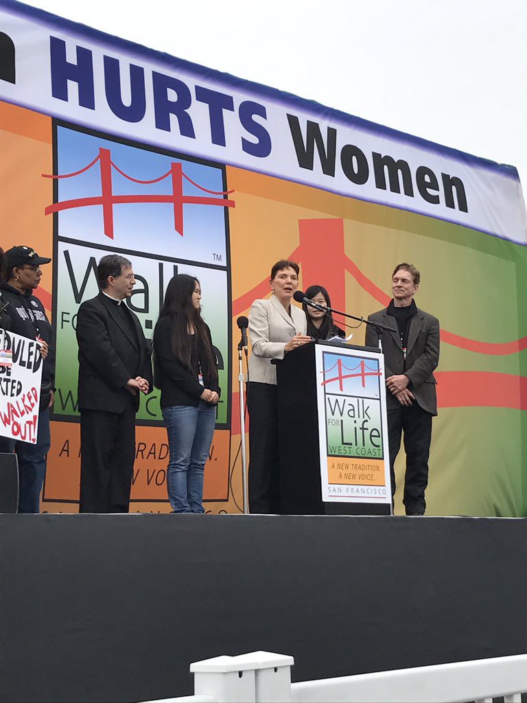 Reggie addresses 50,000 at the West Coast Walk for Life, flanked by husband Rob, daughters Anni and Ruli Zhang, Fr. Frank Pavone, President of Priests for LIfe, and Lori Hoye, Co-Head of the Issues4Life Foundation.